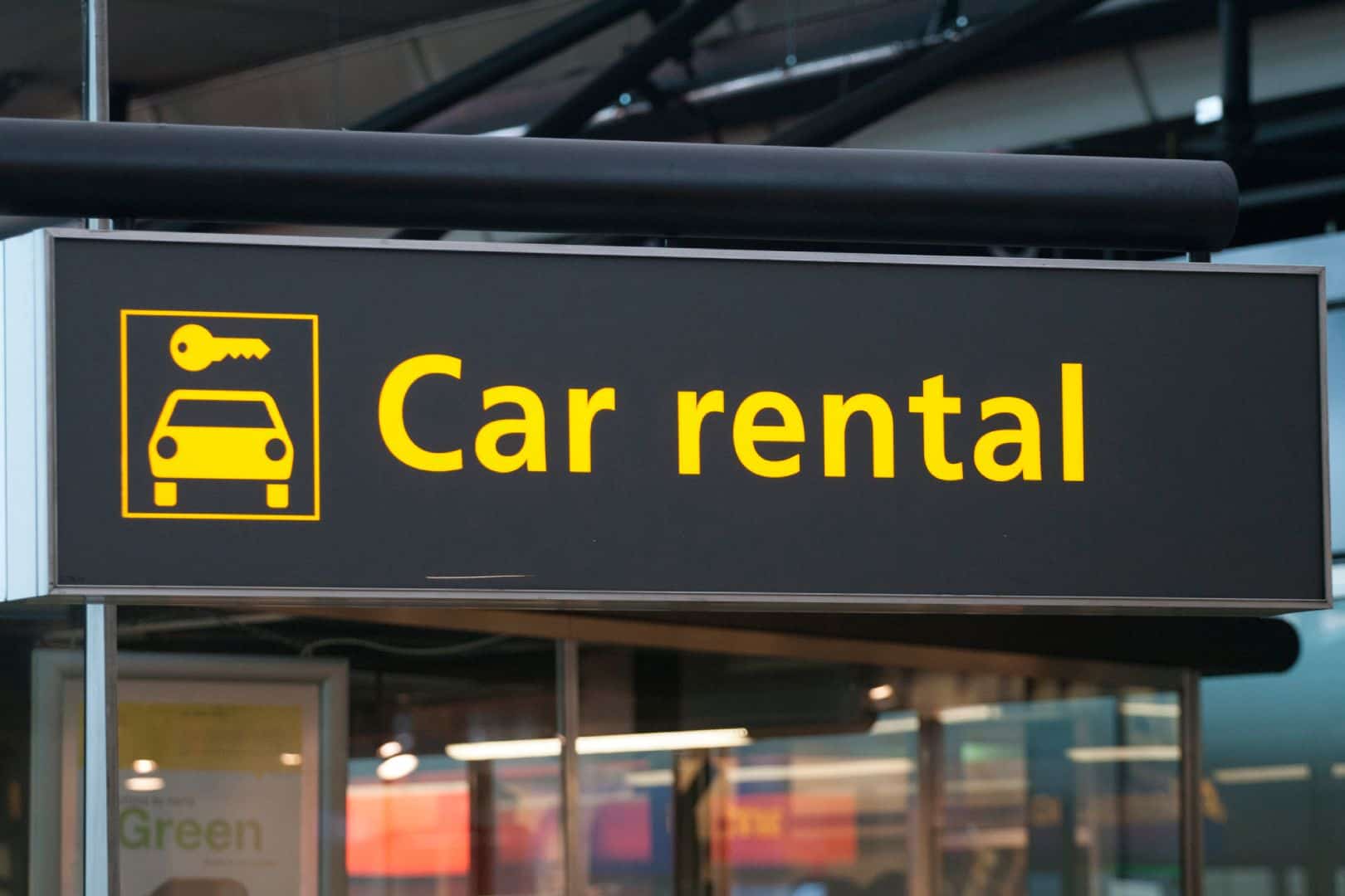An airport car rental sign.