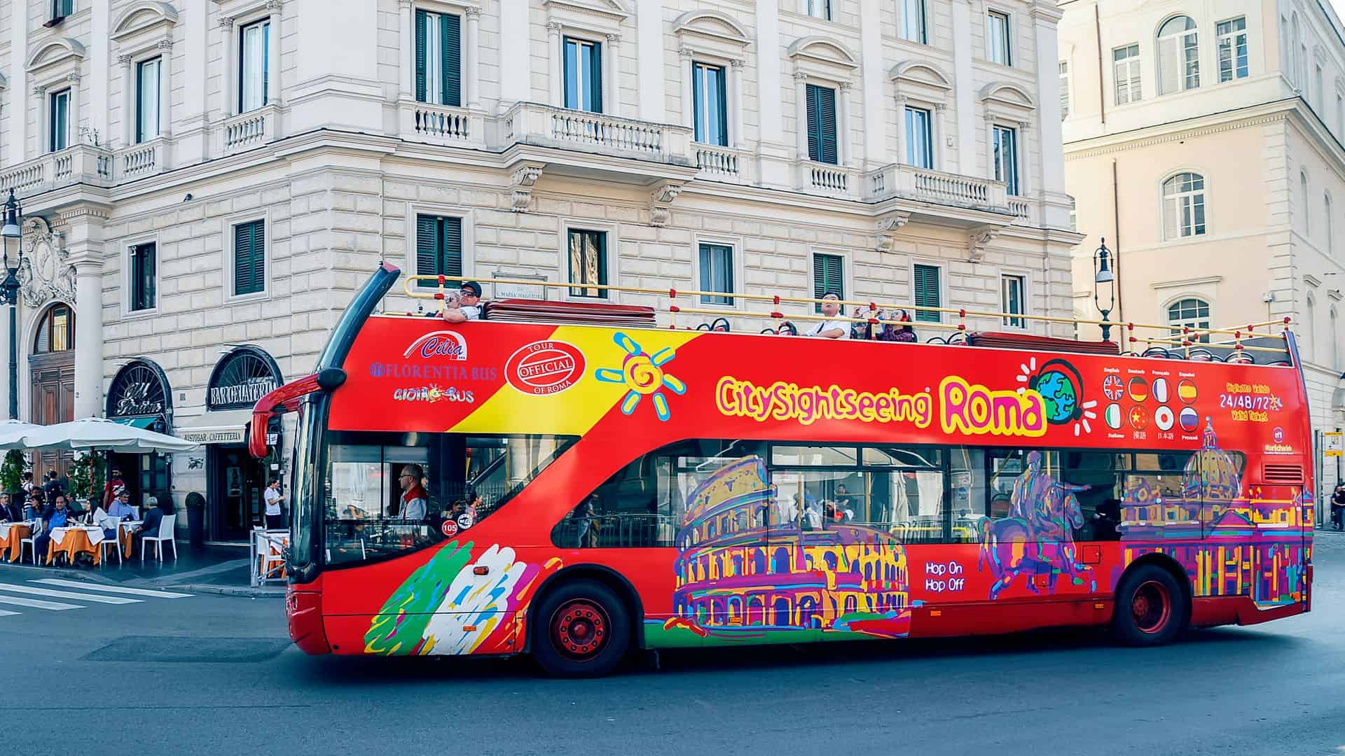 A red double-decker hop-on hop-off bus in Rome