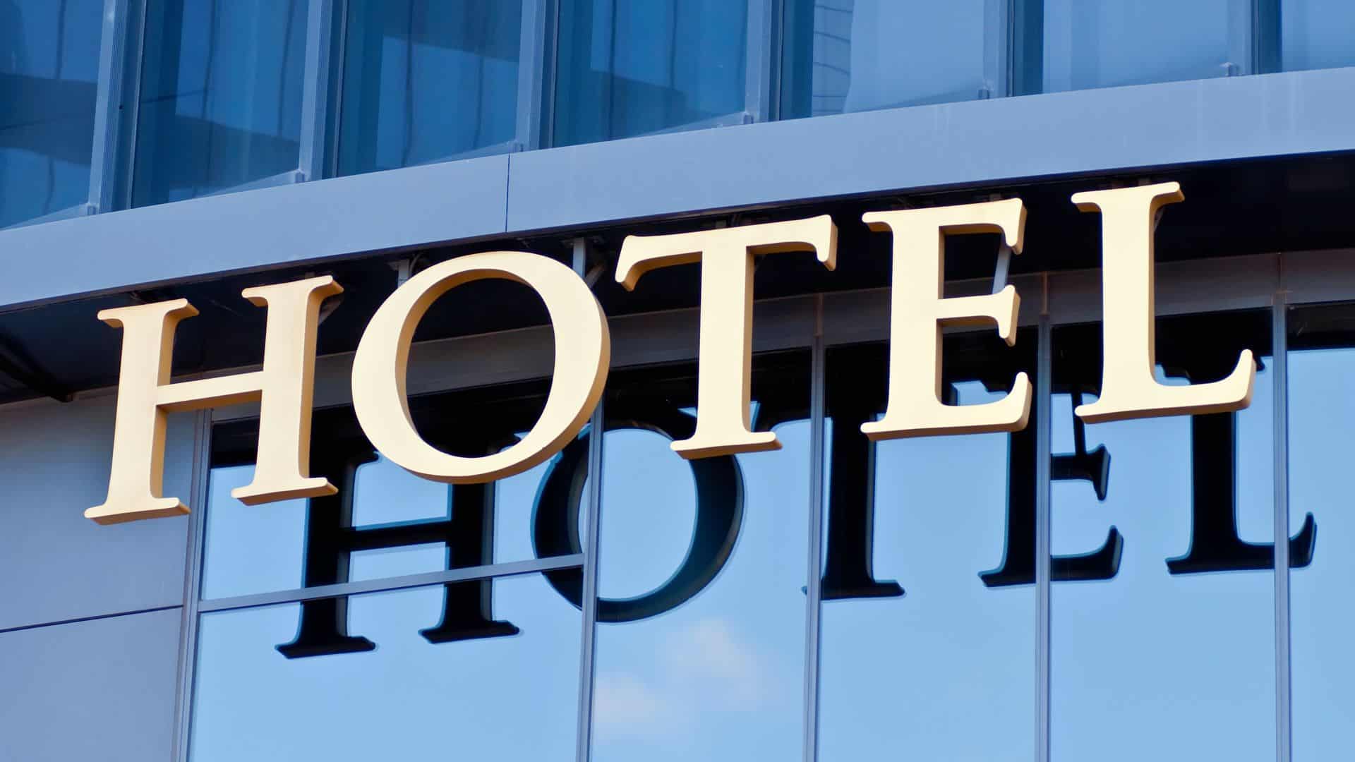 A generic Hotel sign against a building.