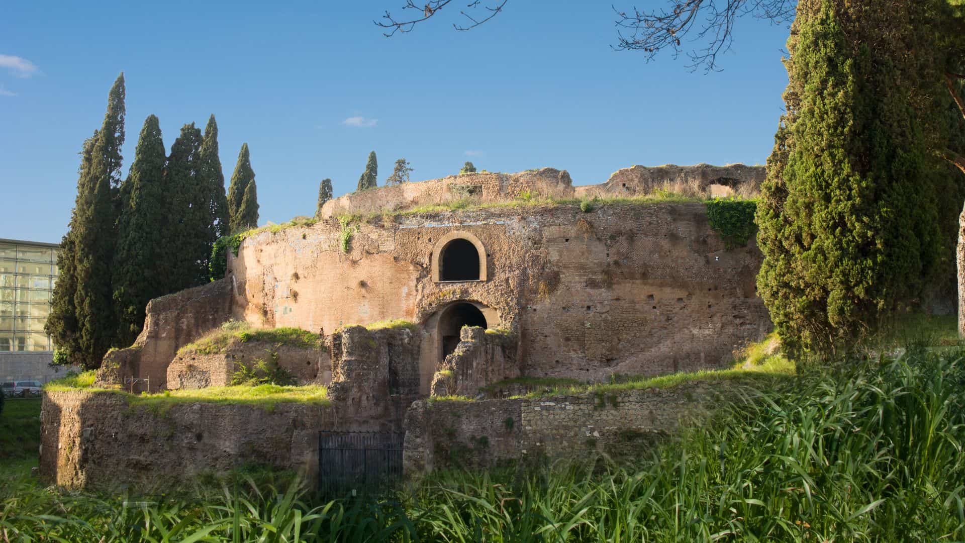 A view of the Mausoleum of Augustus from the outside on a sunny day.