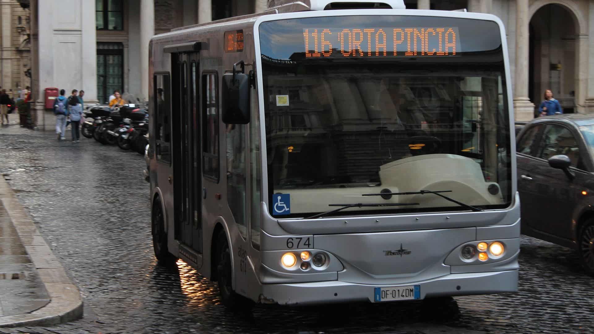 A minibus driving down a street in Rome